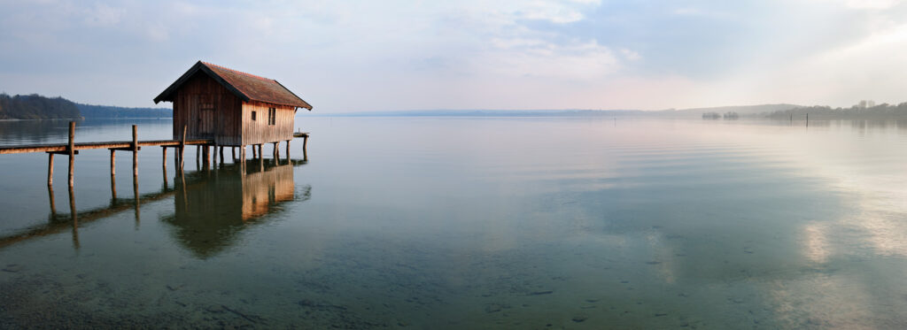 Fishing Hut by Calm Lake at Sunset, Clouds Reflecting in the Wat